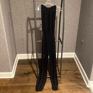 Black jumpsuit, distressed, see through. Size medium.